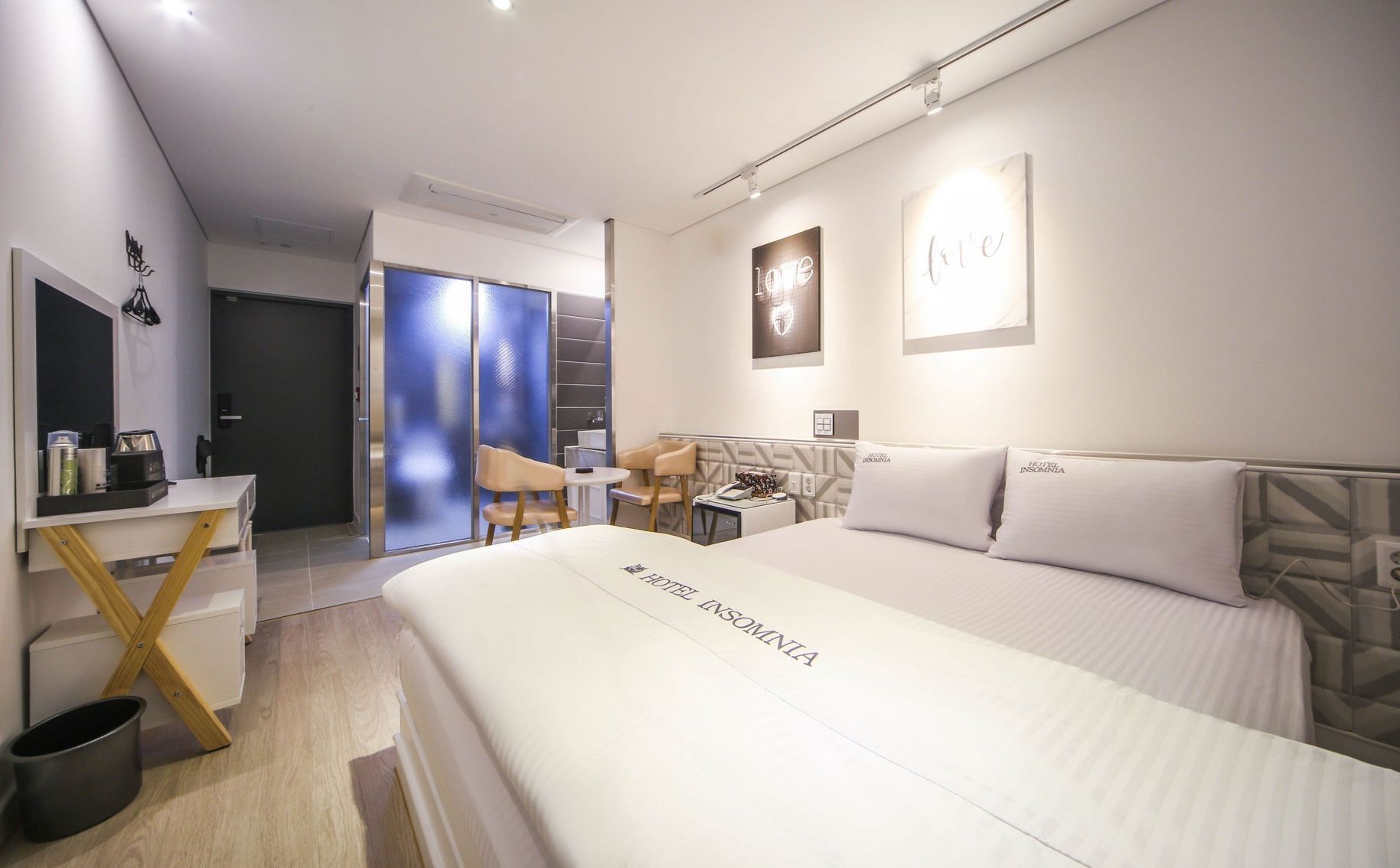 Premium bedding, memory foam beds, laptop workspace, blackout drapes