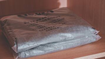 A plastic bag with text on it, placed on a wooden surface.