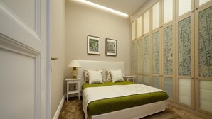 A bedroom with a large bed, two bedside tables, a nightstand, and a wall-mounted lamp.