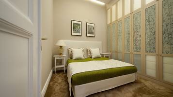 A bedroom with a large bed, two bedside tables, a nightstand, and a wall-mounted lamp.