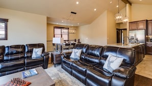 A spacious living room with leather sofas, a coffee table, and a chess set. - Luxury Home, Private Hot Tub, Enjoy Keystone, Breckenridge, A Basin, Copper! (Keystone)