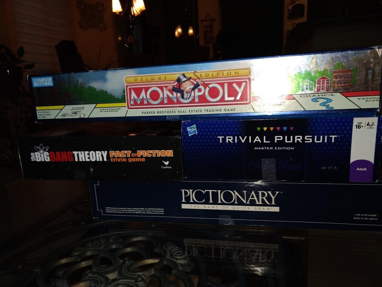 A collection of board games including Monopoly, Trivial Pursuit, and Pictionary.