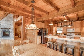 Enjoy cooking in this well-equipped kitchen with a large island, refrigerator, and microwave.