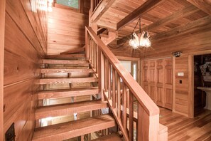 Staircase leads to an upper level with a door.