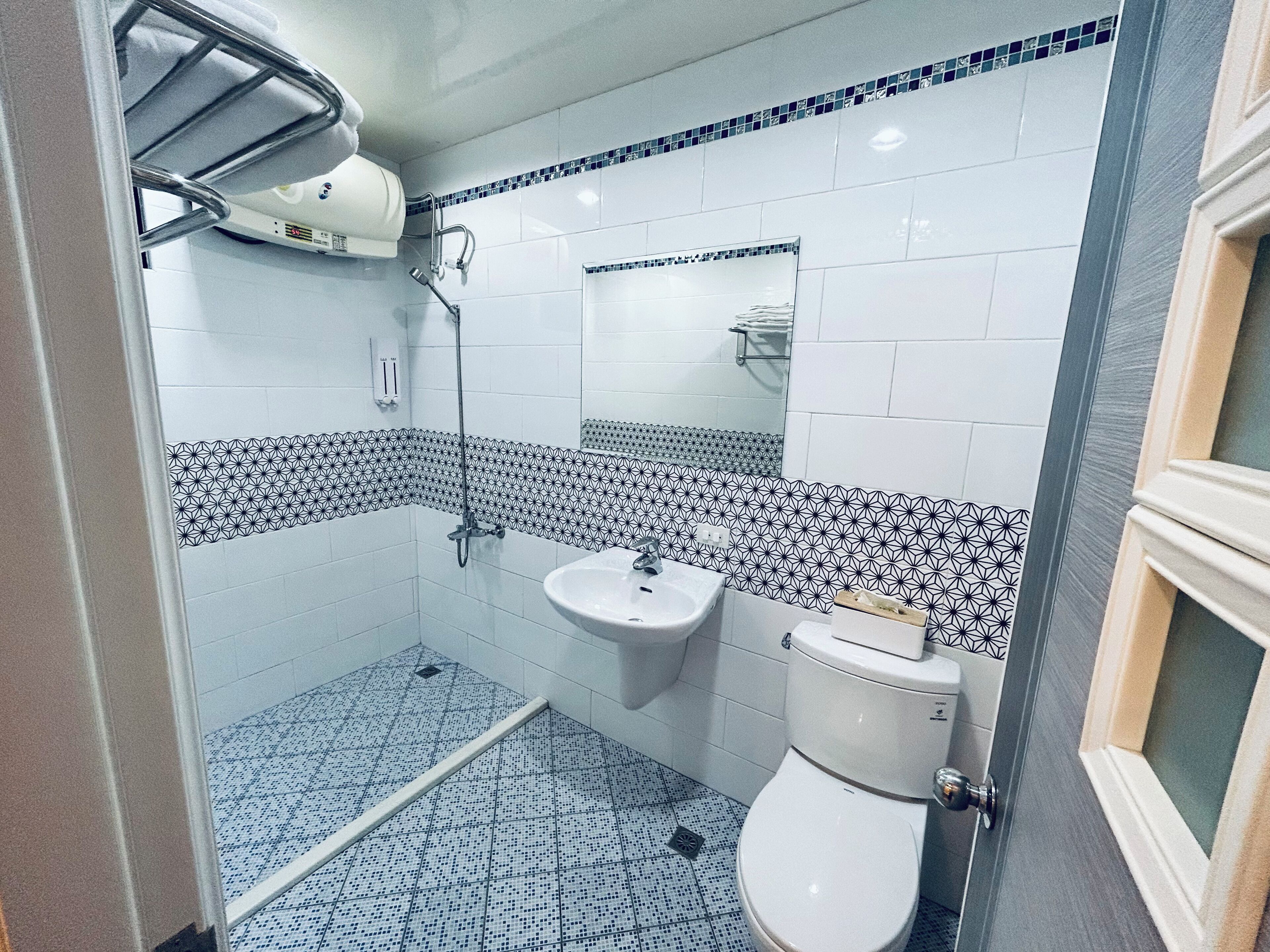 A bathroom with a shower, sink, and toilet.