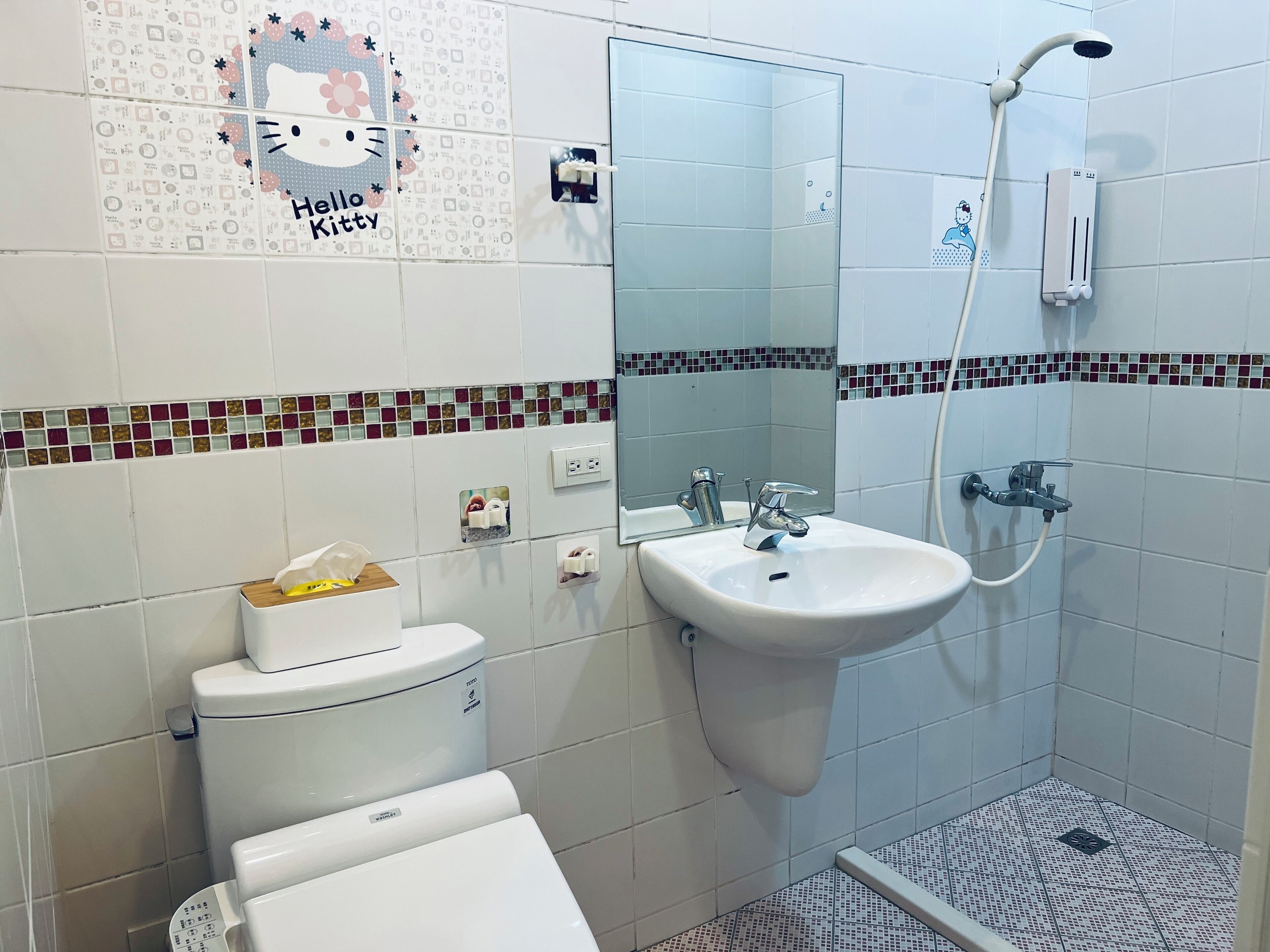 A bathroom with a toilet, sink, and shower.