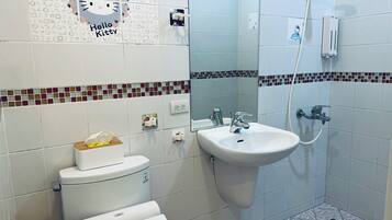 A bathroom with a toilet, sink, and shower.