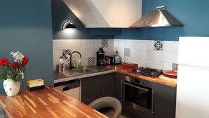 A modern kitchen with a wooden countertop, stainless steel sink, and a gas stove. - very nice house, near downtown (Dol-de-Bretagne)