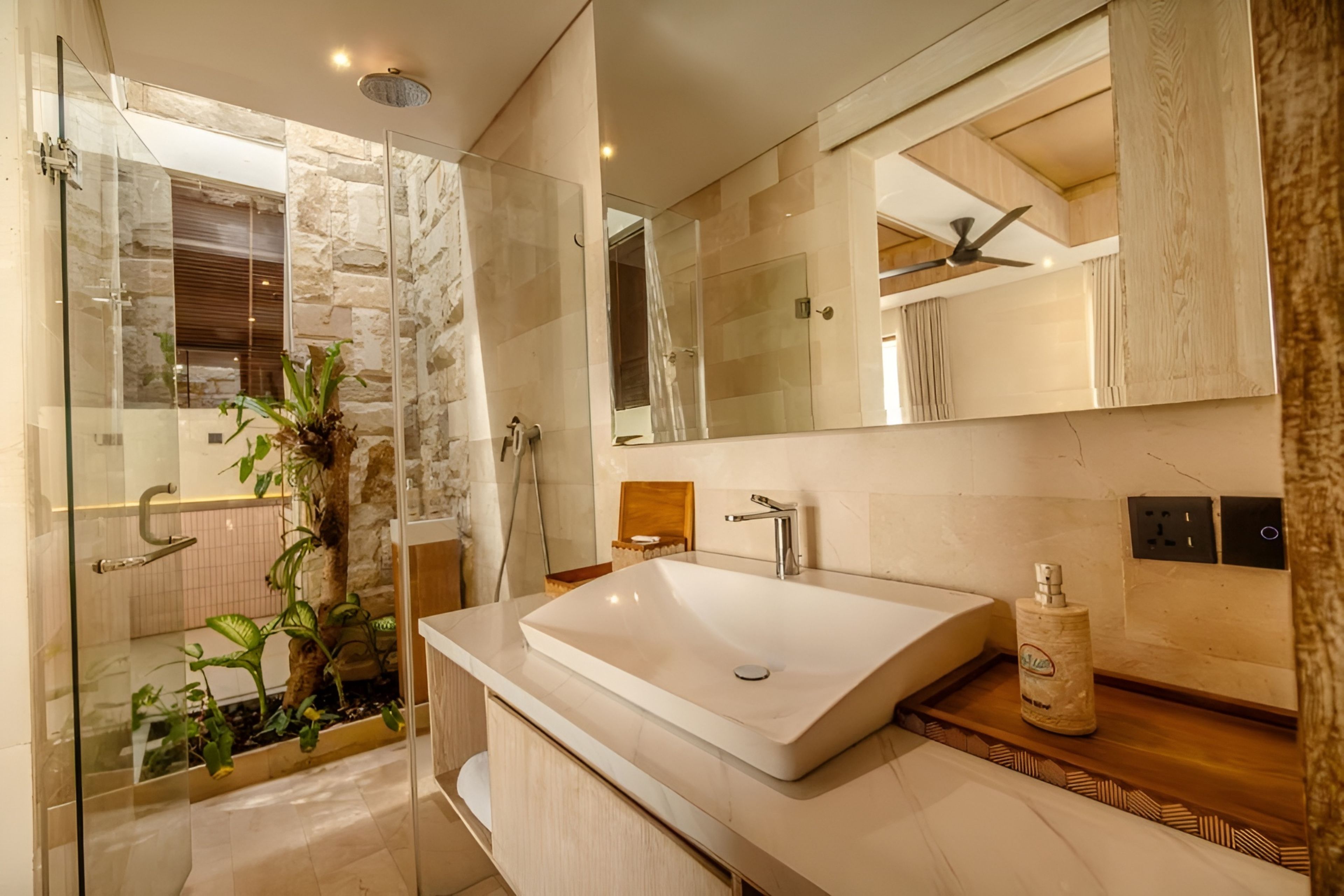 A modern bathroom with a glass shower enclosure, a large mirror, and a vessel sink.
