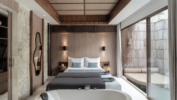 A modern bedroom with a large bed, a bathtub, and a sliding glass door to a balcony. - La Vie Villa Seminyak by Ini Vie Hospitality (Legian)