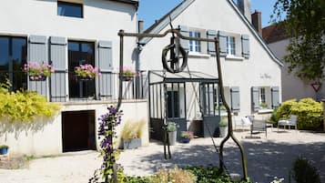 Traditional building with a balcony, swing, and seating area.