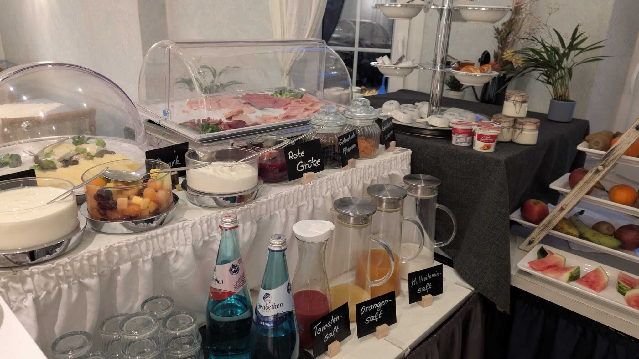 A buffet with various food items and condiments.