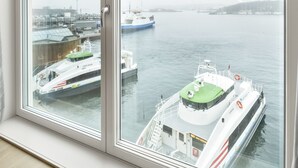 A view from a room with large windows overlooking a harbor with boats. - VANDER - Sea Story (Stavanger)