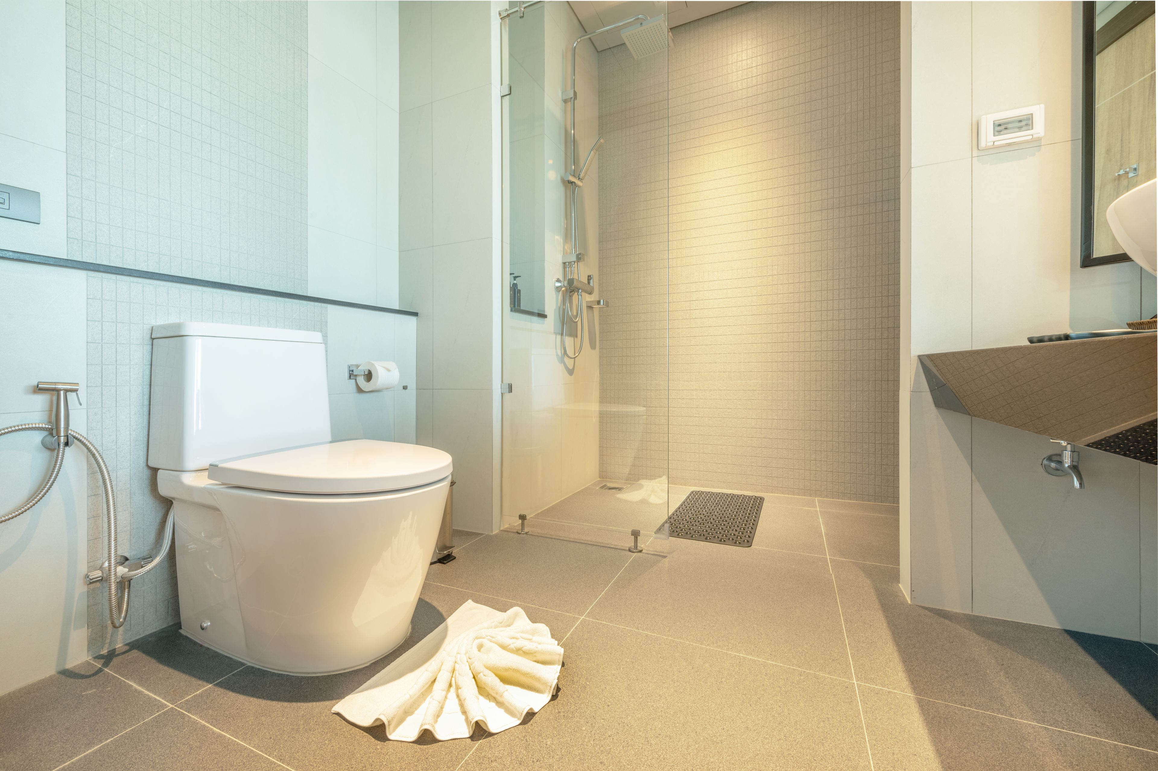 Un baño moderno con inodoro, ducha y lavabo.