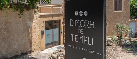A sign for 'Dimora dei Templi' indicating bed and breakfast services.