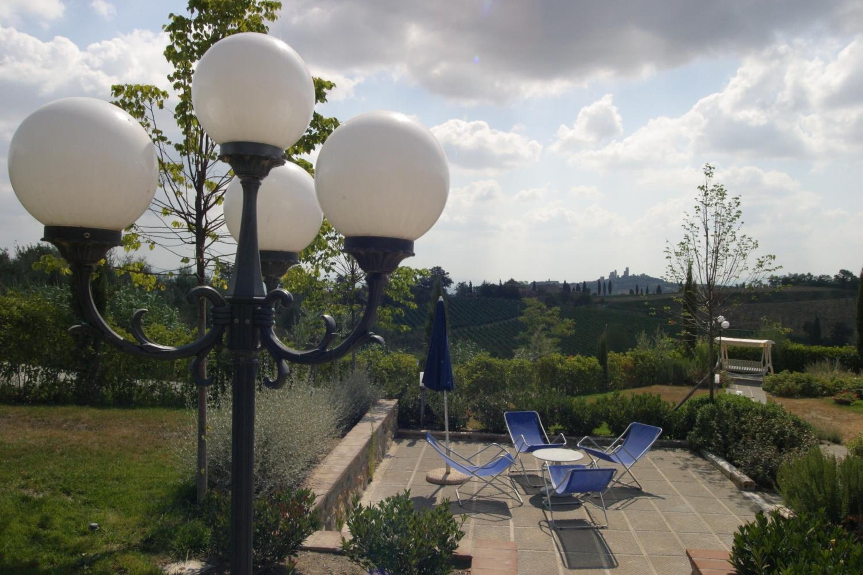 A patio with outdoor seating and a lamp post.