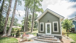 A small, single-story house with a front porch, a mailbox, and a number '288' on the side. - Coop's Coop: A newly renovated studio cottage (Hendersonville)