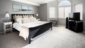 A bedroom with a large bed, bedside tables, a TV, and artwork on the wall. - Super Location, Free Parking, 3 Bedroom + Loft, 3.5 Ba, Sleeps 10, Tesla Charger (Seattle)