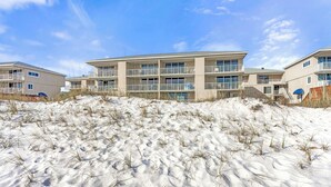 A beachfront hotel with multiple balconies and a sandy beach in the foreground. - Gulf Front 2BR Condo• 2 Balconies • Panoramic Gulf Views • Starboard Village 422 (Pensacola Beach)