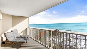A balcony with two lounge chairs and a view of the beach. - Gulf Front 2BR Condo• 2 Balconies • Panoramic Gulf Views • Starboard Village 422 (Pensacola Beach)