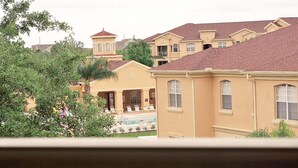 A residential area with multiple houses, a swimming pool, and lush greenery. - Magical Florida Getaway. (Davenport)