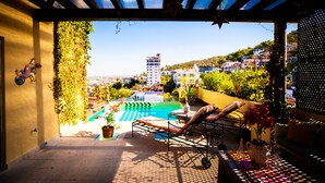 A rooftop pool area with lounge chairs and potted plants. - Private, Staffed Old Vallarta Casa with Rooftop Views, Art, Pool, & Walkability (Puerto Vallarta)