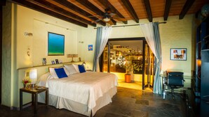 A bedroom with a bed, a nightstand, a ceiling fan, and a view of the outside. - Private, Staffed Old Vallarta Casa with Rooftop Views, Art, Pool, & Walkability (Puerto Vallarta)