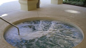 A hot tub with a metal ladder, surrounded by a tiled floor. - Ridge Castle (Davenport)