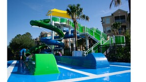 A water park with multiple slides and a pool area. - Magical Memory Maker (Kissimmee)