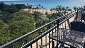 A balcony with a view of a beach, palm trees, and the ocean. - Rare Unobstructed Diamond Head-Ocean Views, Best location, Pool, 1 minute to Beach (Honolulu)
