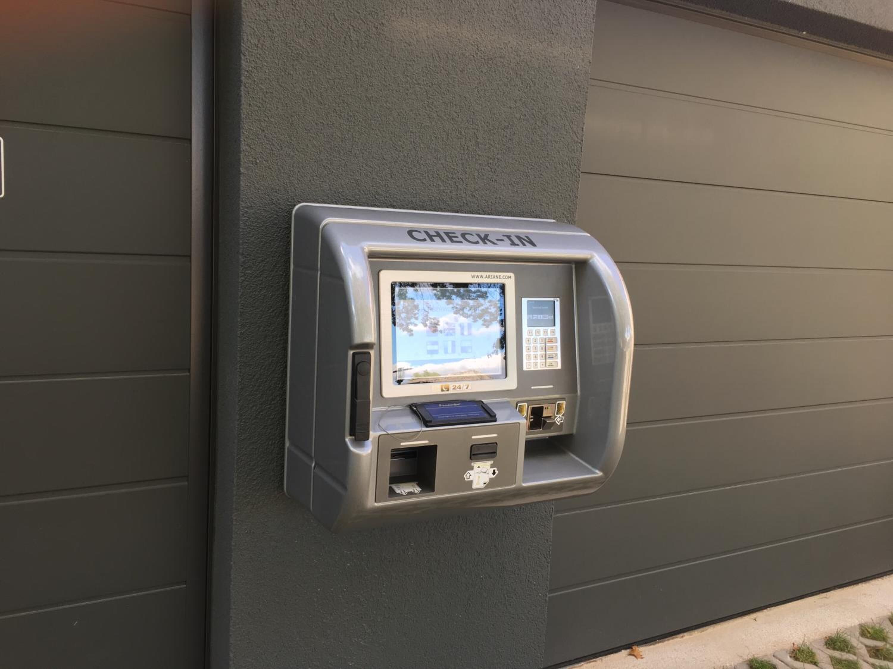 A check-in kiosk mounted on a wall.