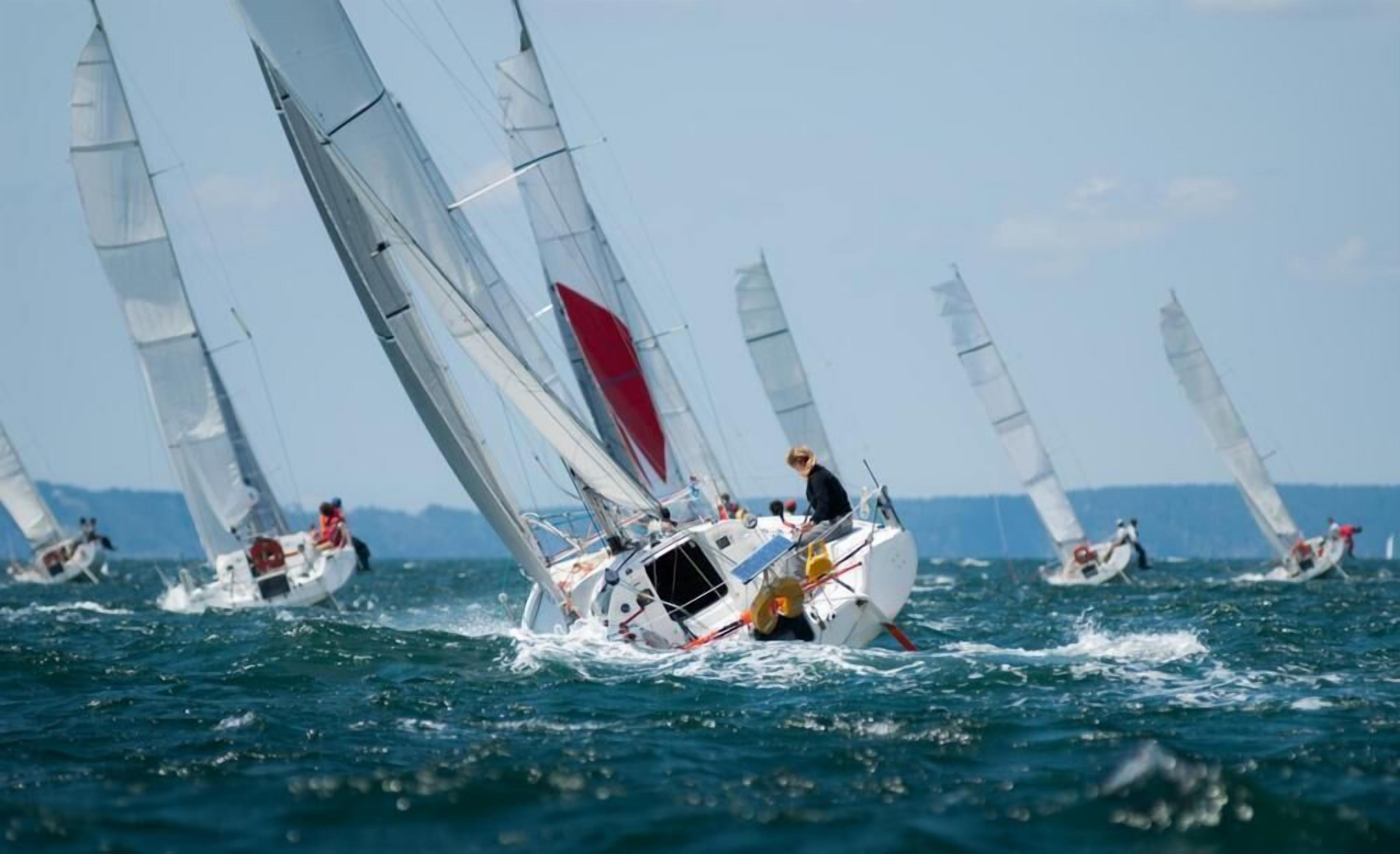 A sailboat race with multiple boats on the water.