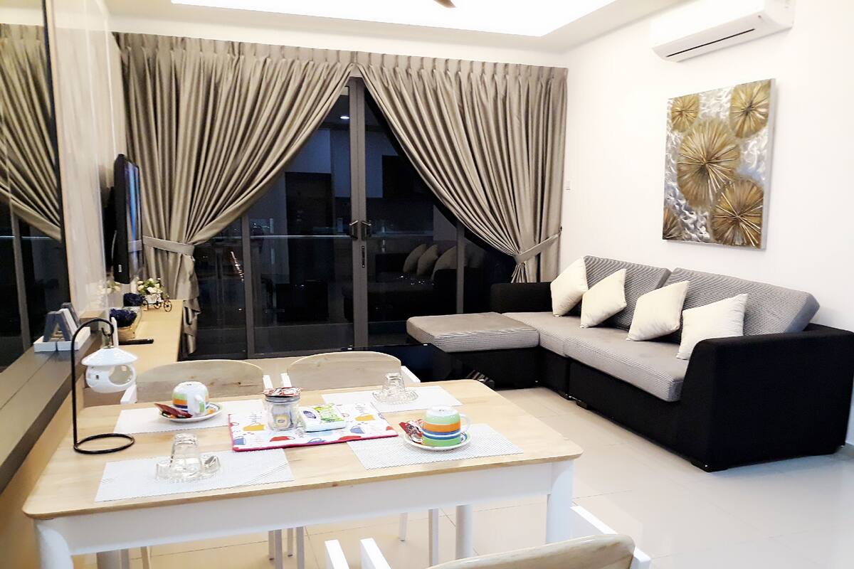 A modern living room with a dining area, a sofa, and a coffee table.