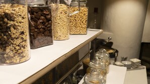 A buffet table with various food items in glass containers.