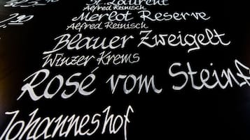 A blackboard with white text listing names and titles, likely of authors or works.