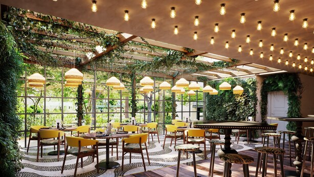 A restaurant with wooden floors, yellow chairs, and hanging light fixtures. - Nordseka hotel The Hague Voorburg (Voorburg)