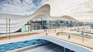 A modern building with a unique curved roof and large glass windows. - Nordseka hotel The Hague Voorburg (Voorburg)