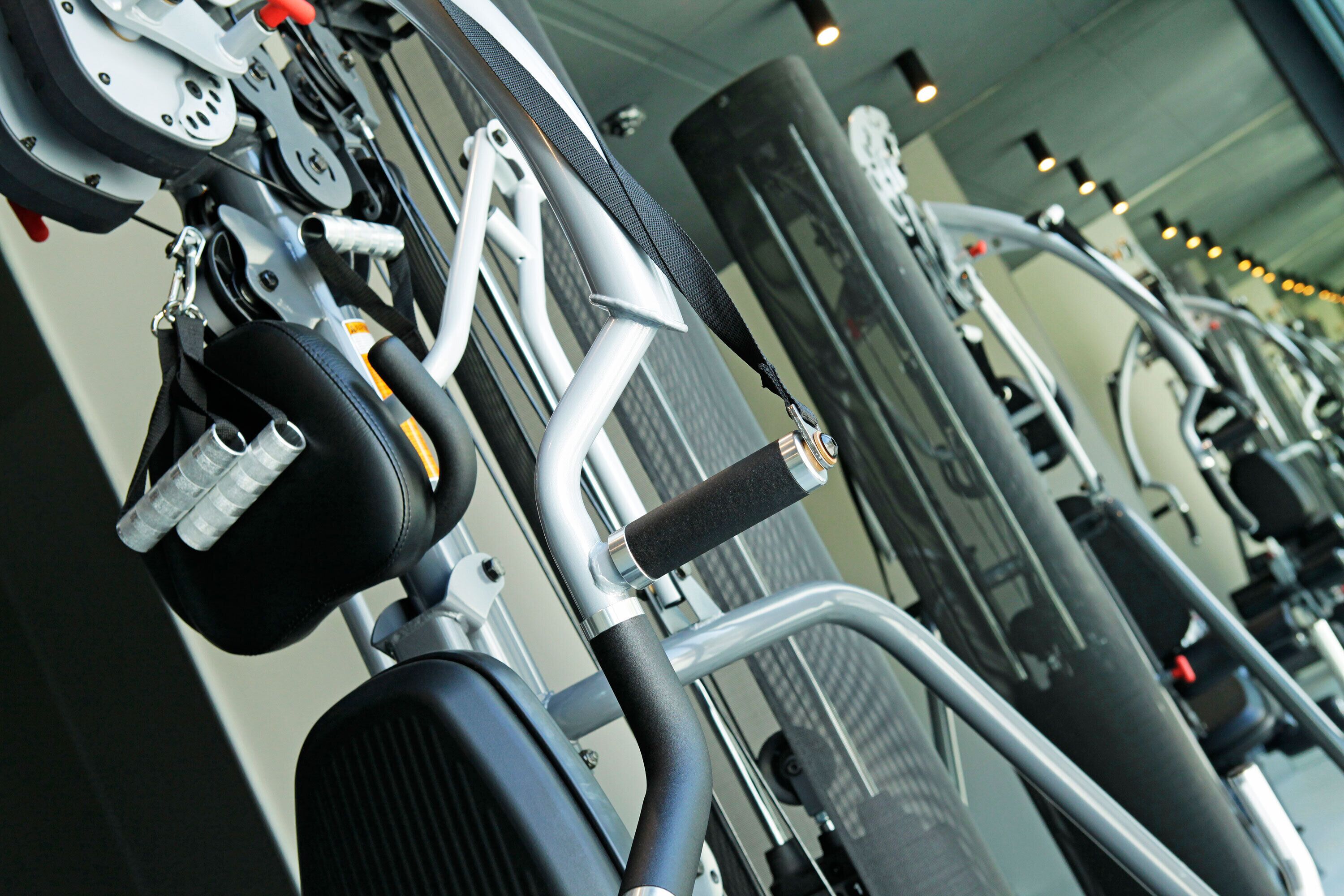 A gym with exercise equipment, including treadmills and weight machines.