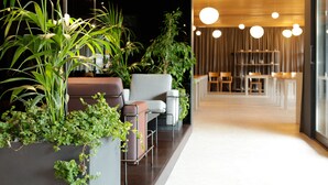 A modern interior with seating areas, indoor plants, and a well-lit dining space. - Lifestyle Hotel Vitar - Adults Only (Bol)
