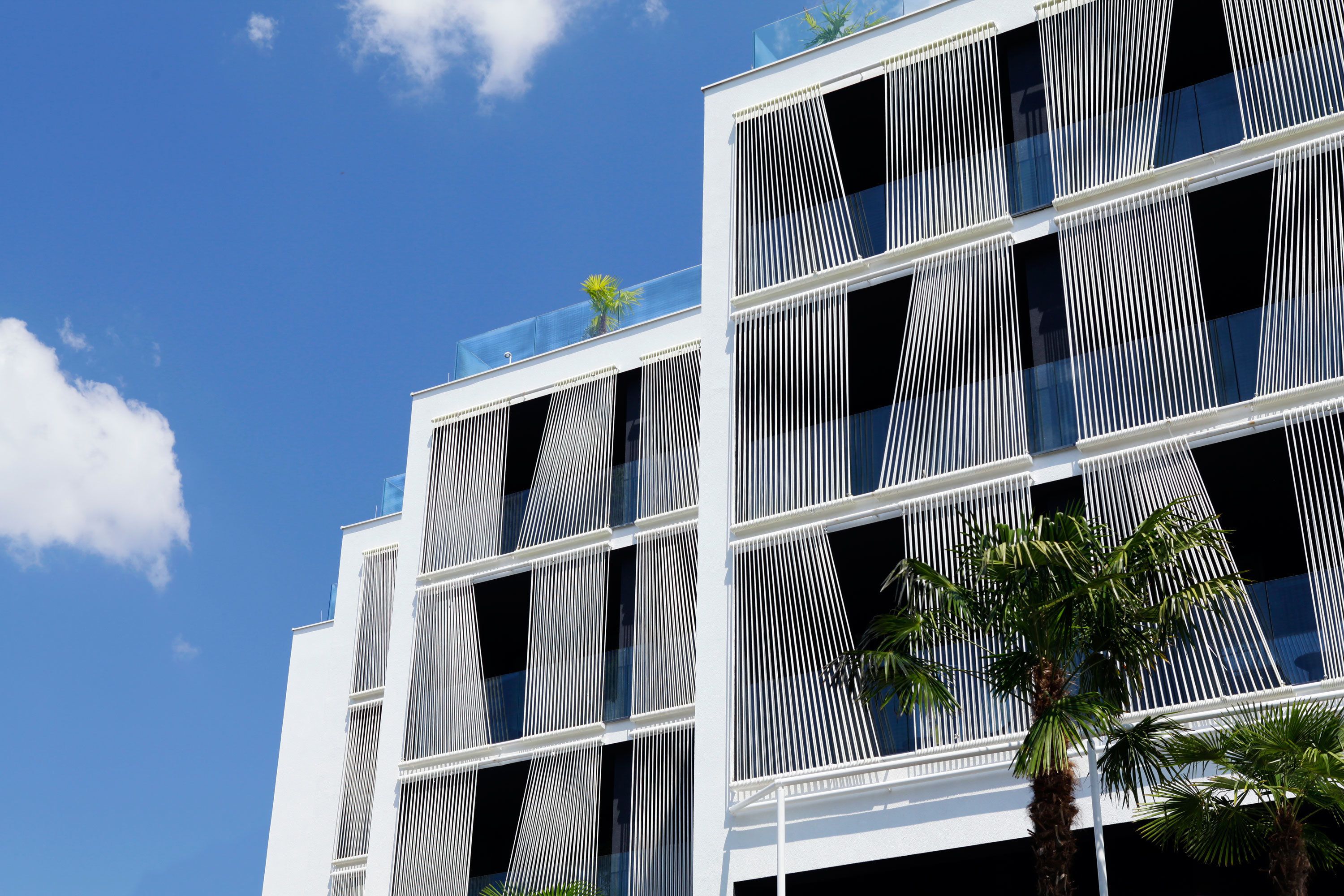 A modern building with a geometric facade and large windows.