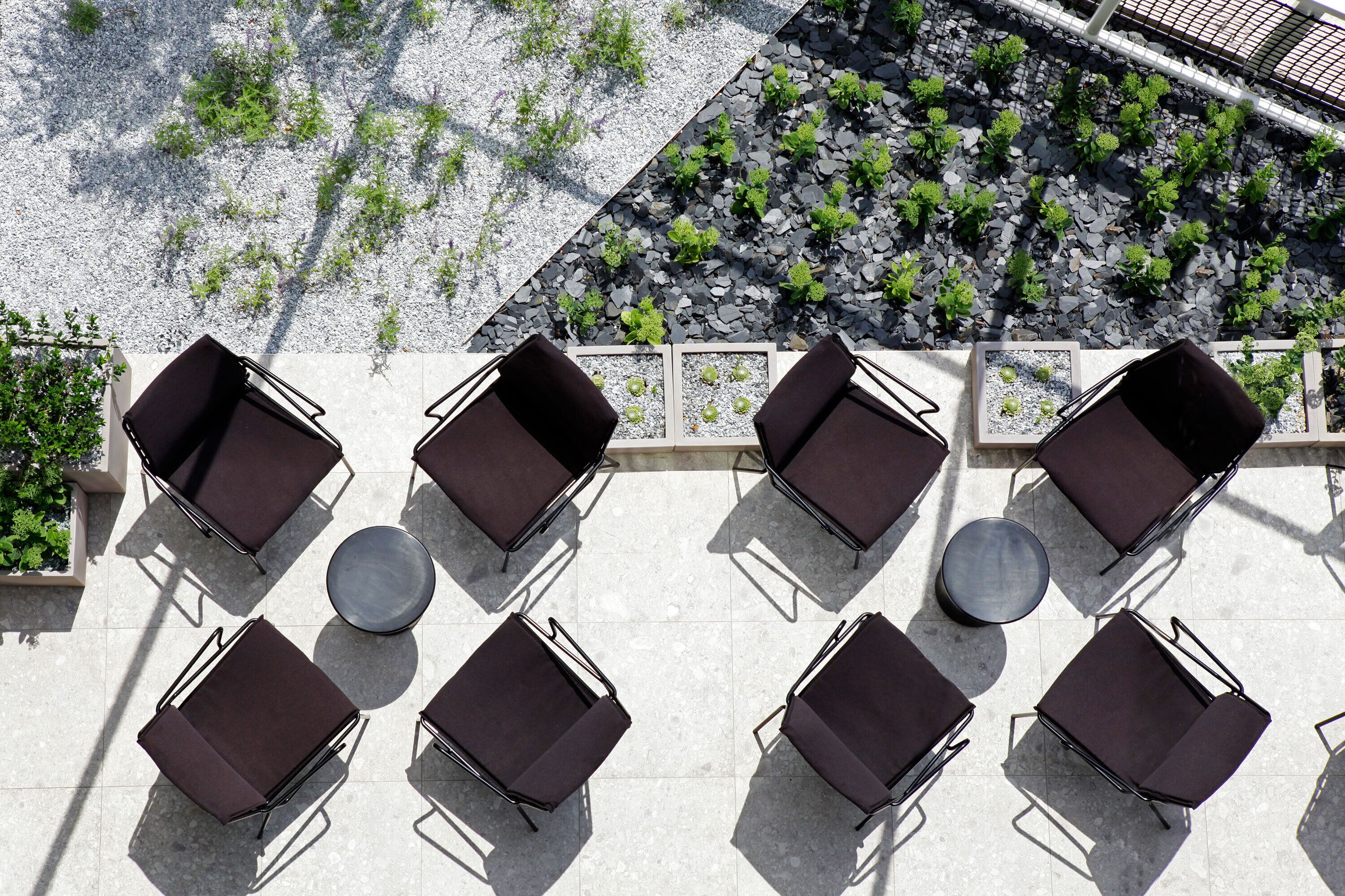 A rooftop terrace with outdoor seating and a garden area.