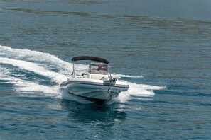 A speedboat on water. - Villa Eight by A (Okrug)