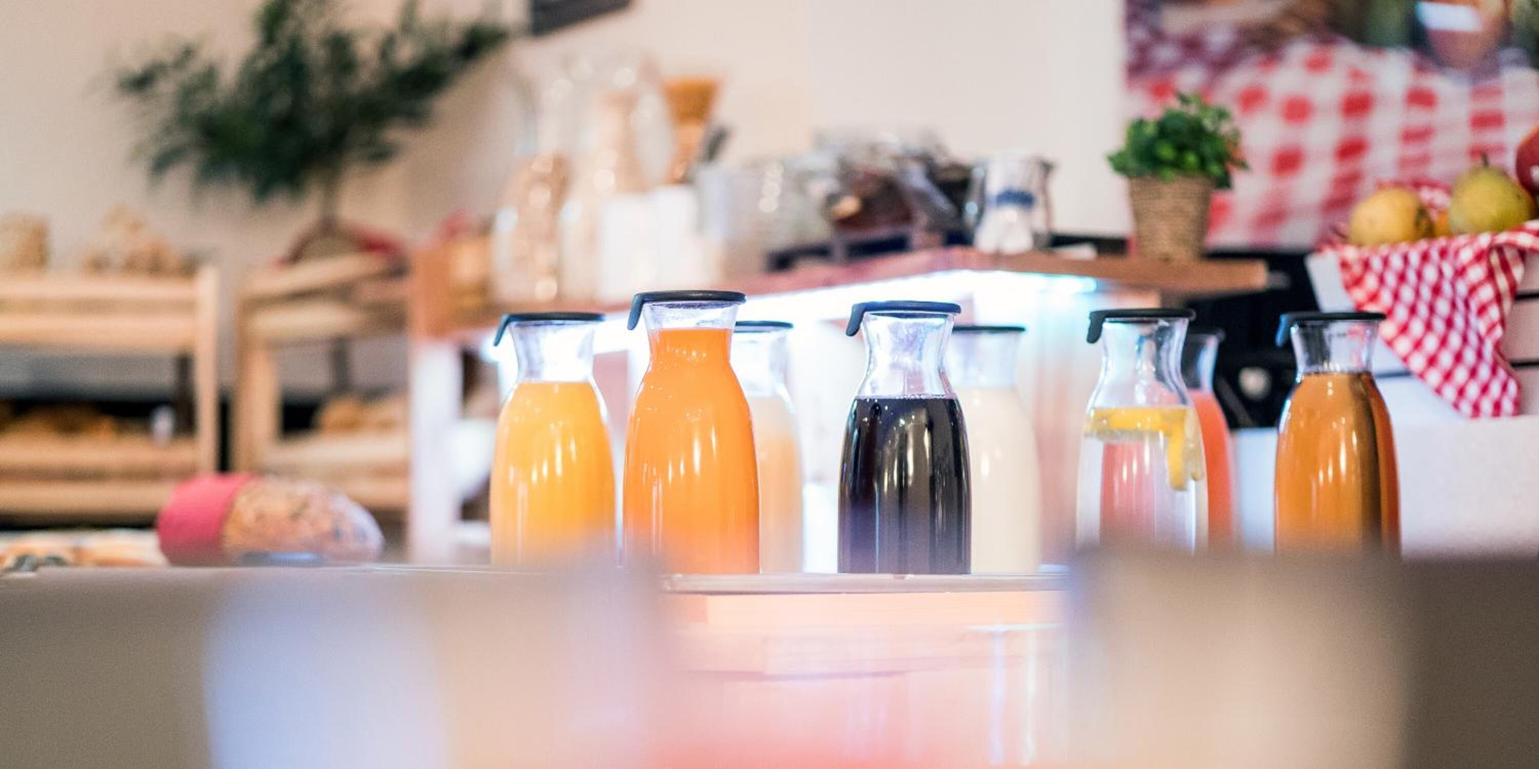 A kitchen counter with various bottles, likely containing beverages or condiments.