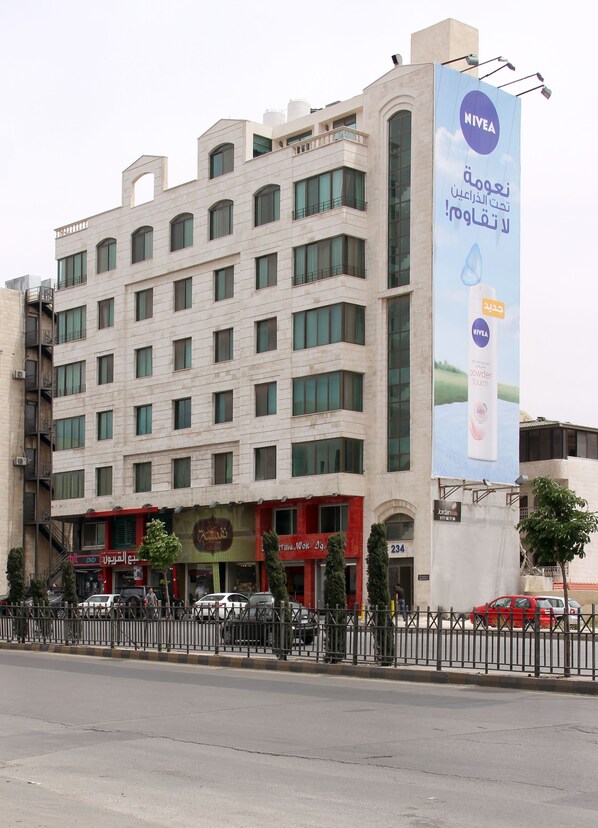 A multi-story hotel with a prominent Nivea advertisement on the facade.