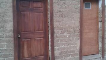 A tiled floor with a wooden door and a window.