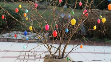 A potted plant with colorful ornaments on its branches.