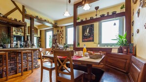 A cozy cafe with wooden furniture, a bar area, and large windows. - La Rose Tremiere (Wintzenheim-Kochersberg)