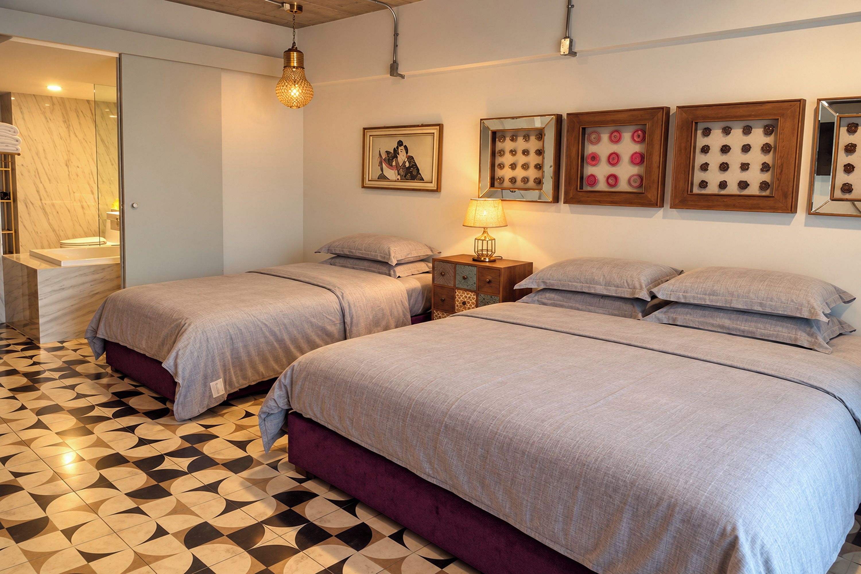 A hotel room with two beds, a bathroom, and a patterned floor.