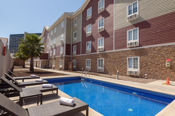Outdoor pool, open 9:00 AM to 8:00 PM, pool umbrellas, pool loungers