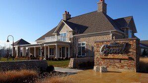 A large, two-story house with a stone facade and a prominent sign reading "Hilliard Grand". - BridgeStreet at Hilliard Grand (Dublin)
